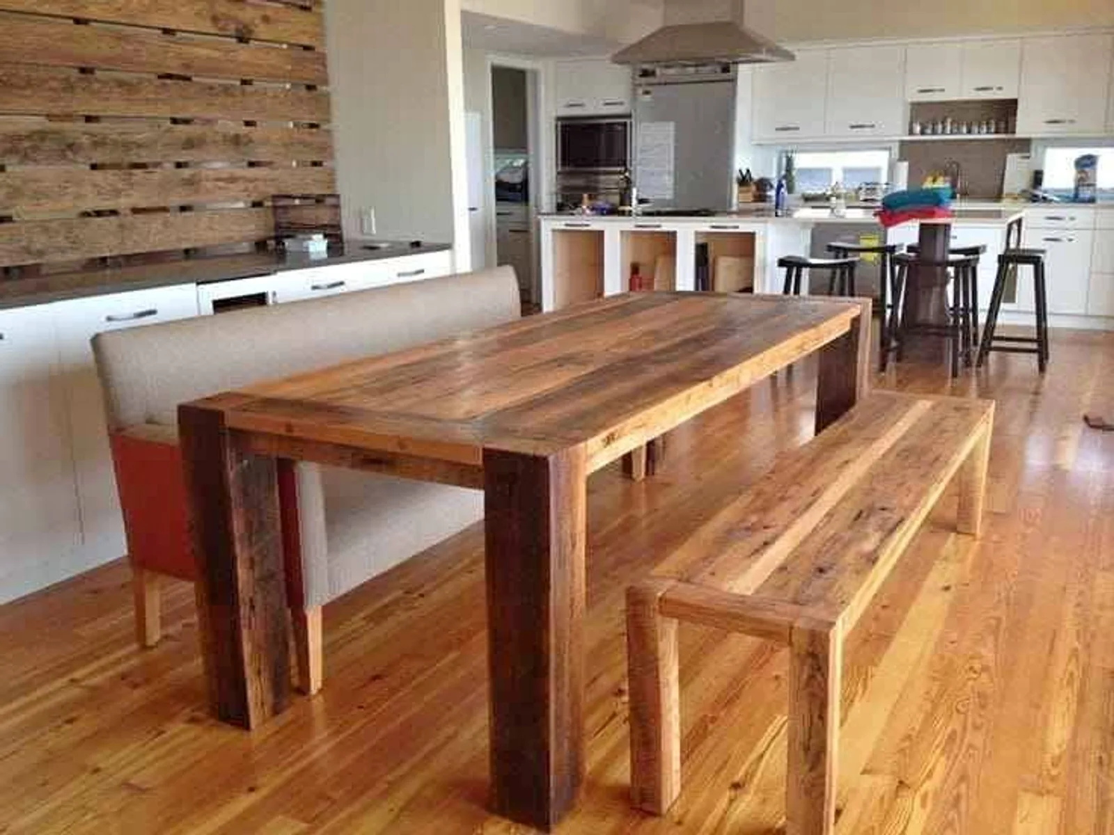 An Oregon pine dining table with two matching benches in a kitchen